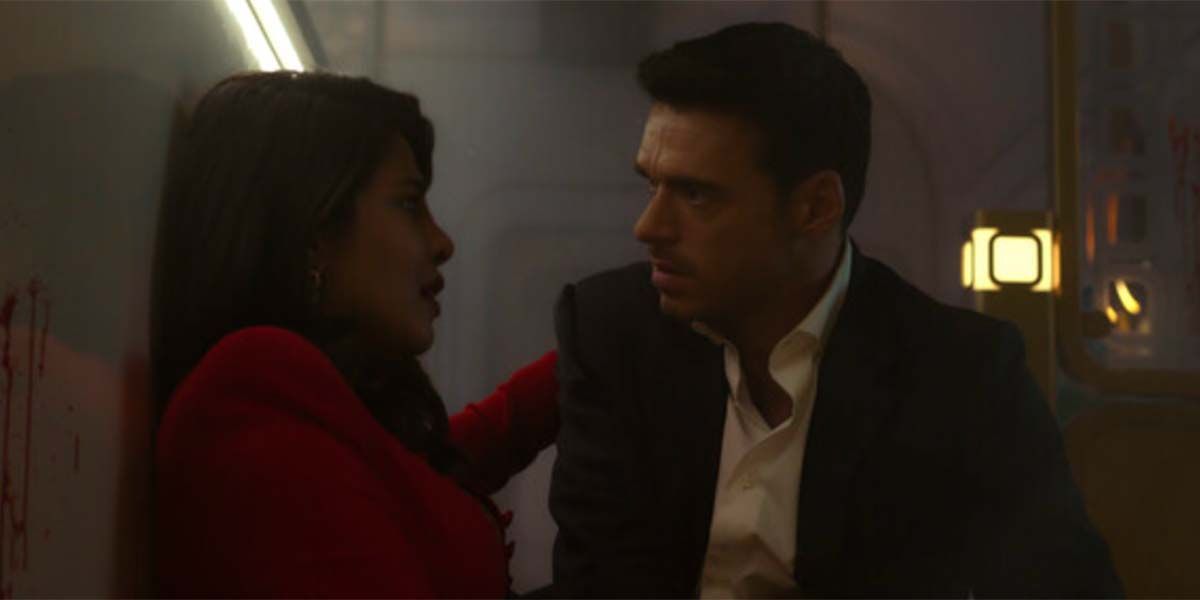 Nadia (Chopra) and Mason (Madden) falling on each other after an explosion in Citadel