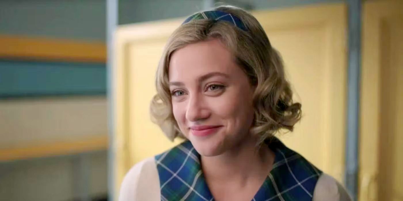 Betty Cooper smiles wearing white and blue plaid