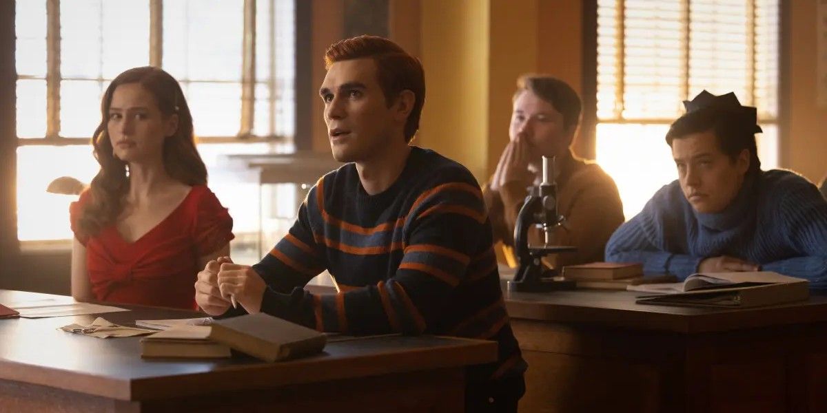 Archie sits at his desk in science class in Riverdale Season 7