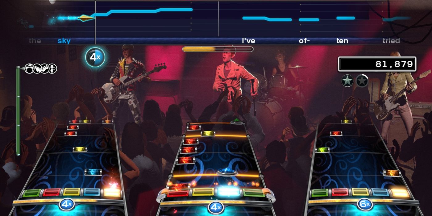 Três jogadores se apresentando no jogo Rock Band 4