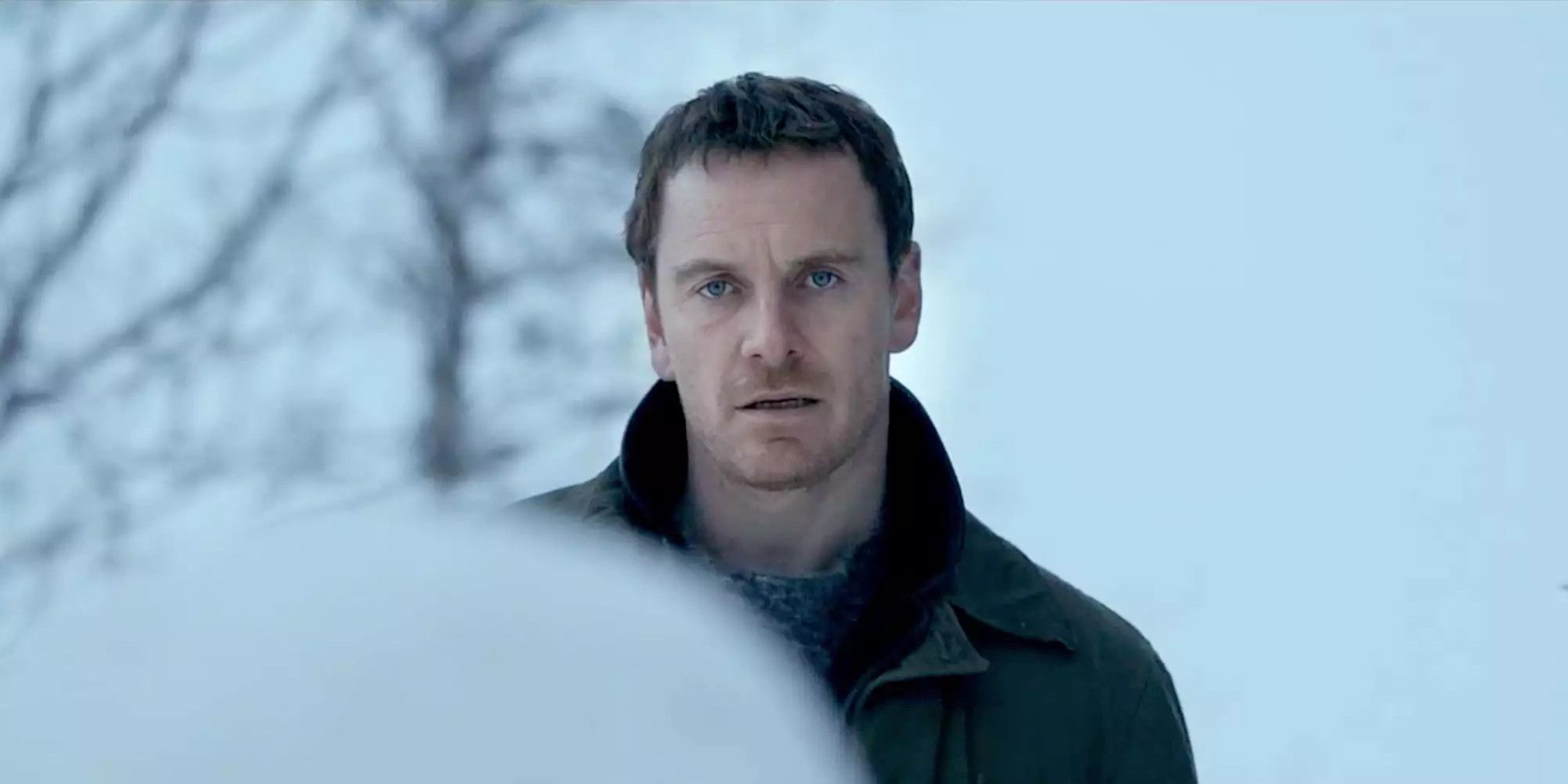 Michael Fassbender stares pensively in image from The Snowman