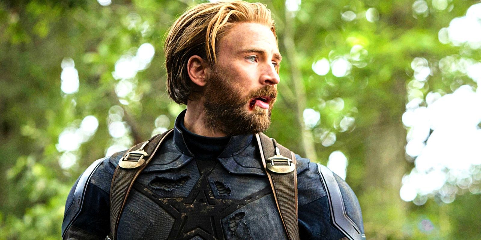 Chris Evans' Captain America looking agape to the right in a tattered uniform