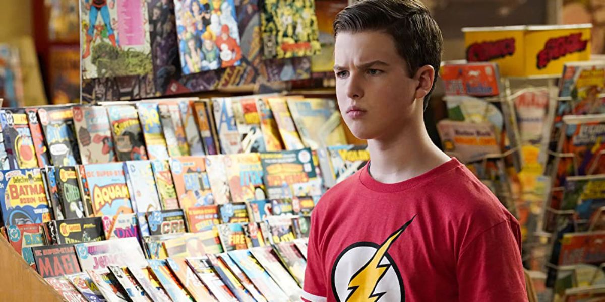 Sheldon Cooper (Iain Armitage) standing inside a comic book store in Young Sheldon.