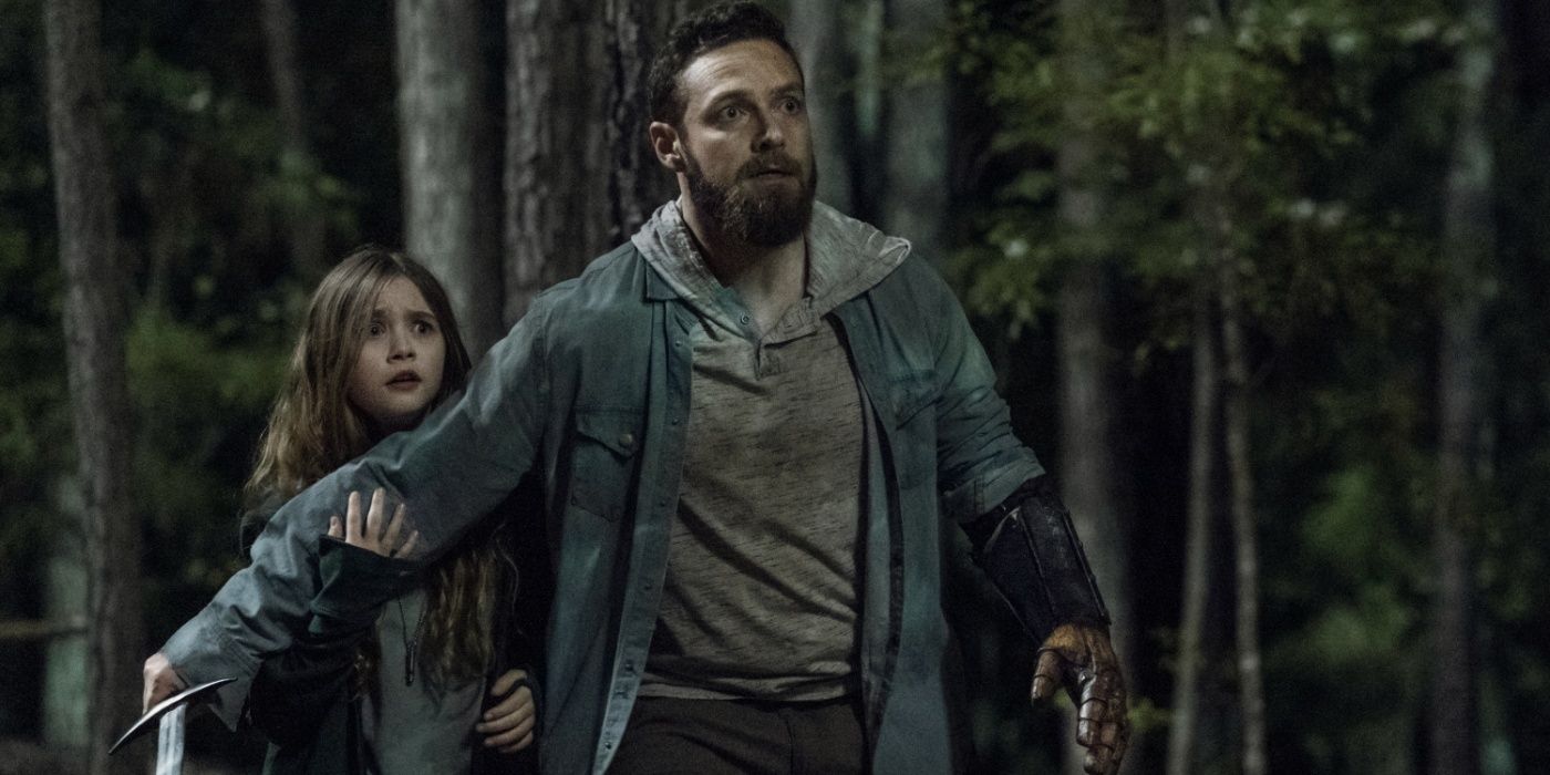 Aaron shielding his daughter Grace in The Walking Dead. 