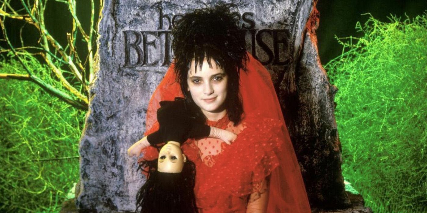 Winona Ryder as Lydia Deetz in front of the grave stone for Beetlejuice.