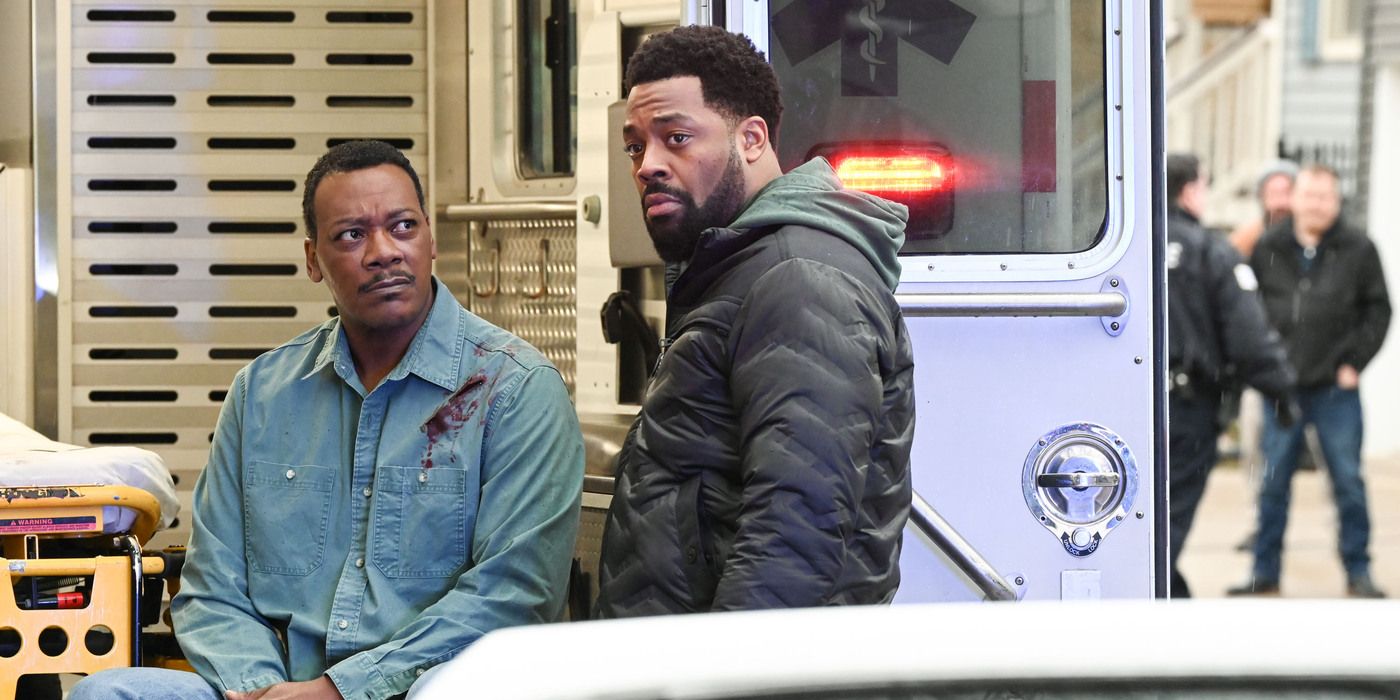 Chicago PD's Atwater (LaRoyce Hawkins) and his dad Lew (Erik LeRay Harvey) talk outside ambulance