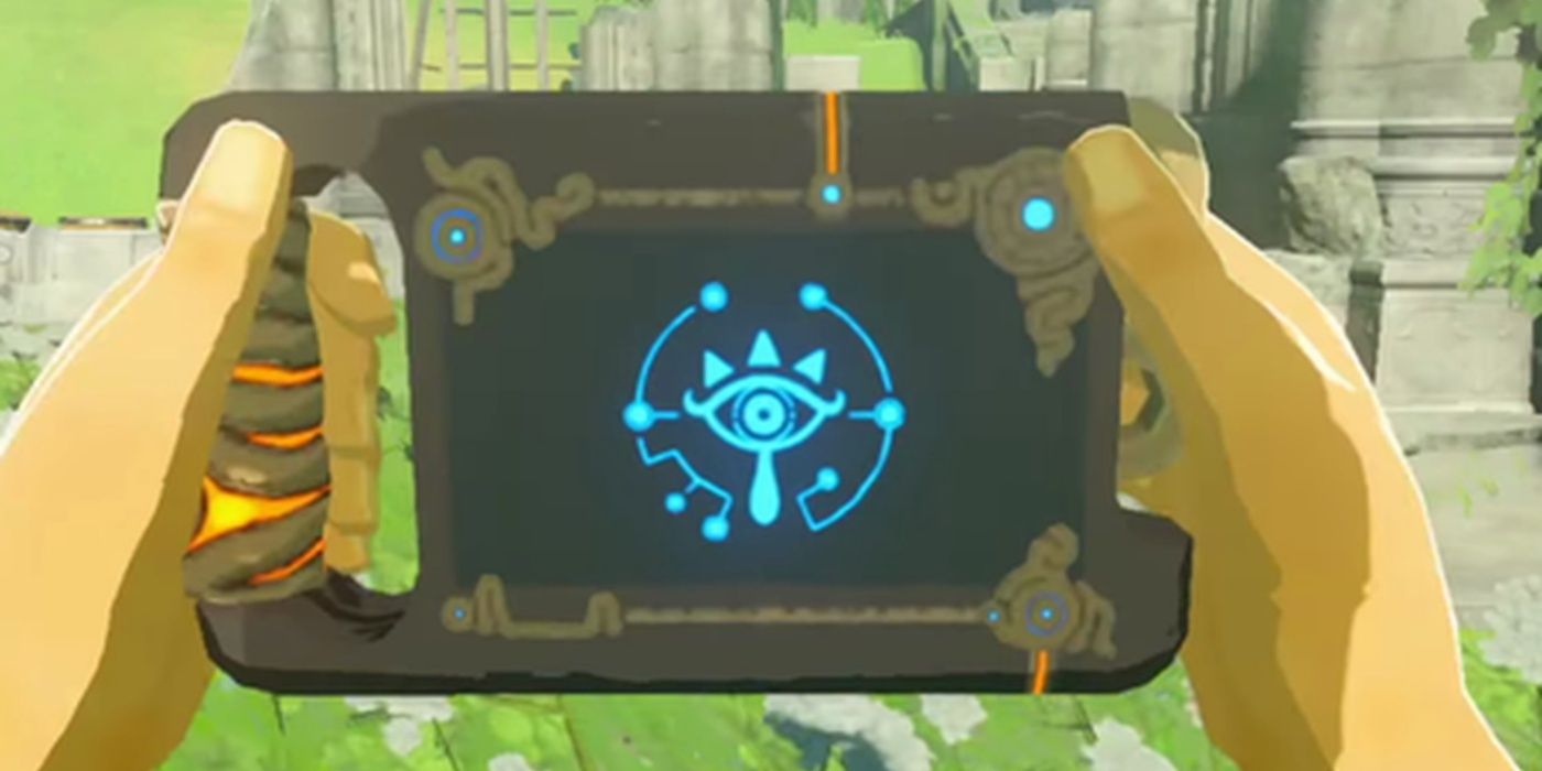 A Sheikah Slate sendo segurada por um jogador em The Legend of Zelda Breath of The Wild