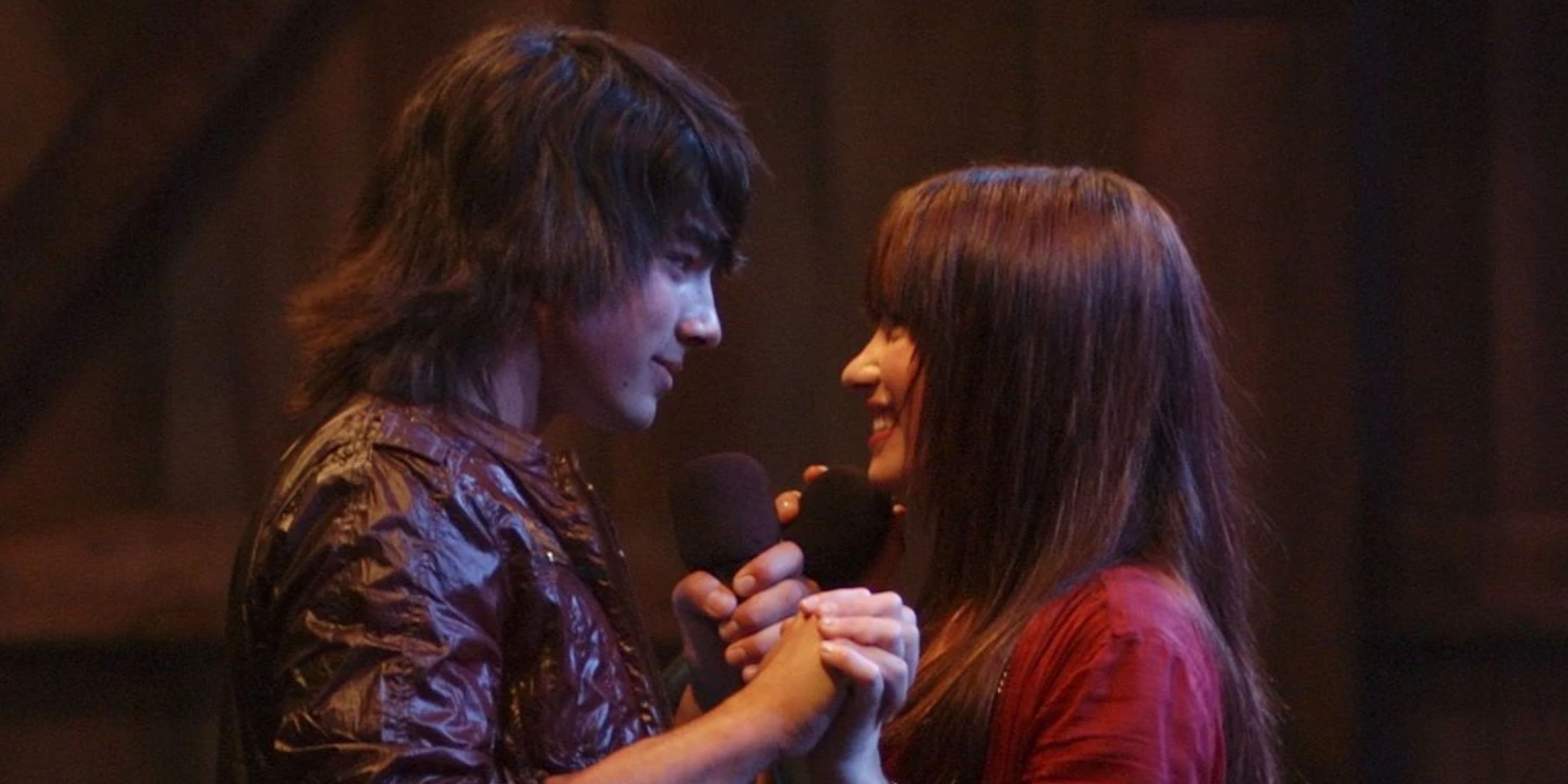 Shane & Mitchie holding hands close together after singing in Camp Rock
