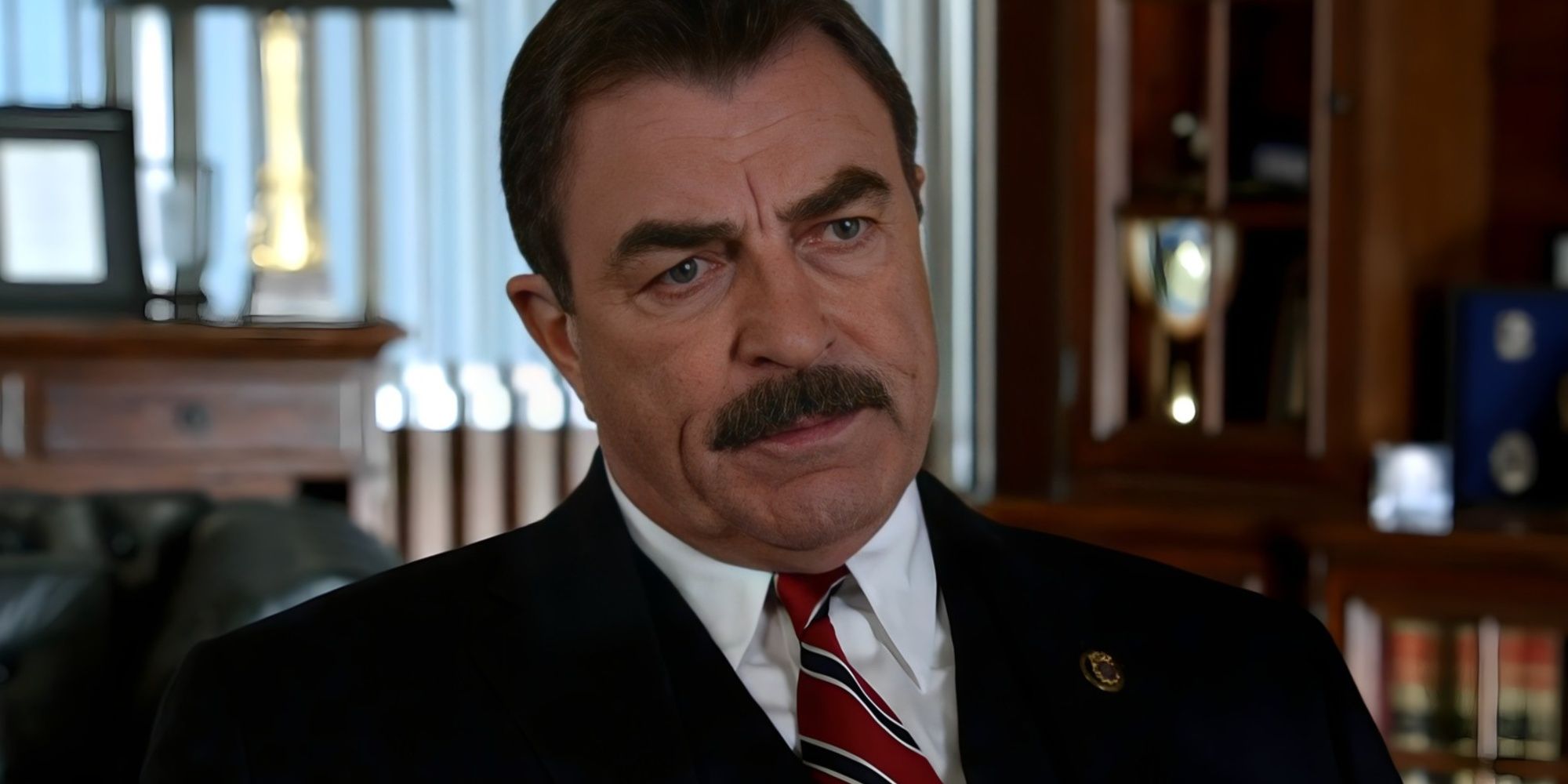 Frank Reagan looks disappointed while sitting in his chair on Blue Bloods