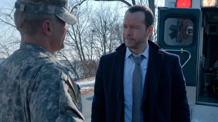 Danny Reagan looks at a solider with a resigned face in Blue Bloods.