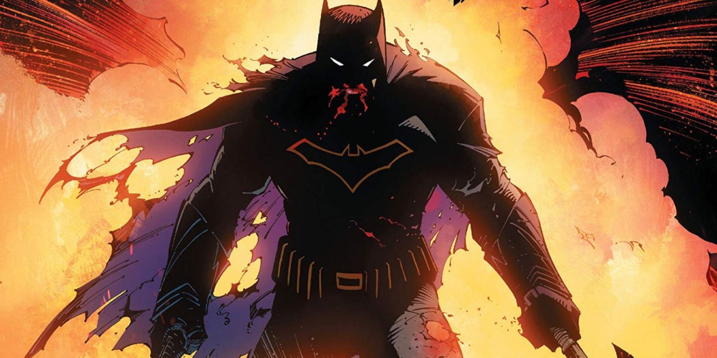 A bloodied Batman wielding two axes and standing in front of an explosion.
