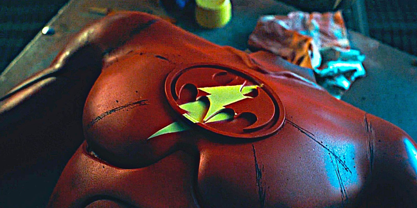 A spray-painted version of The Flash's suit lying on a workbench