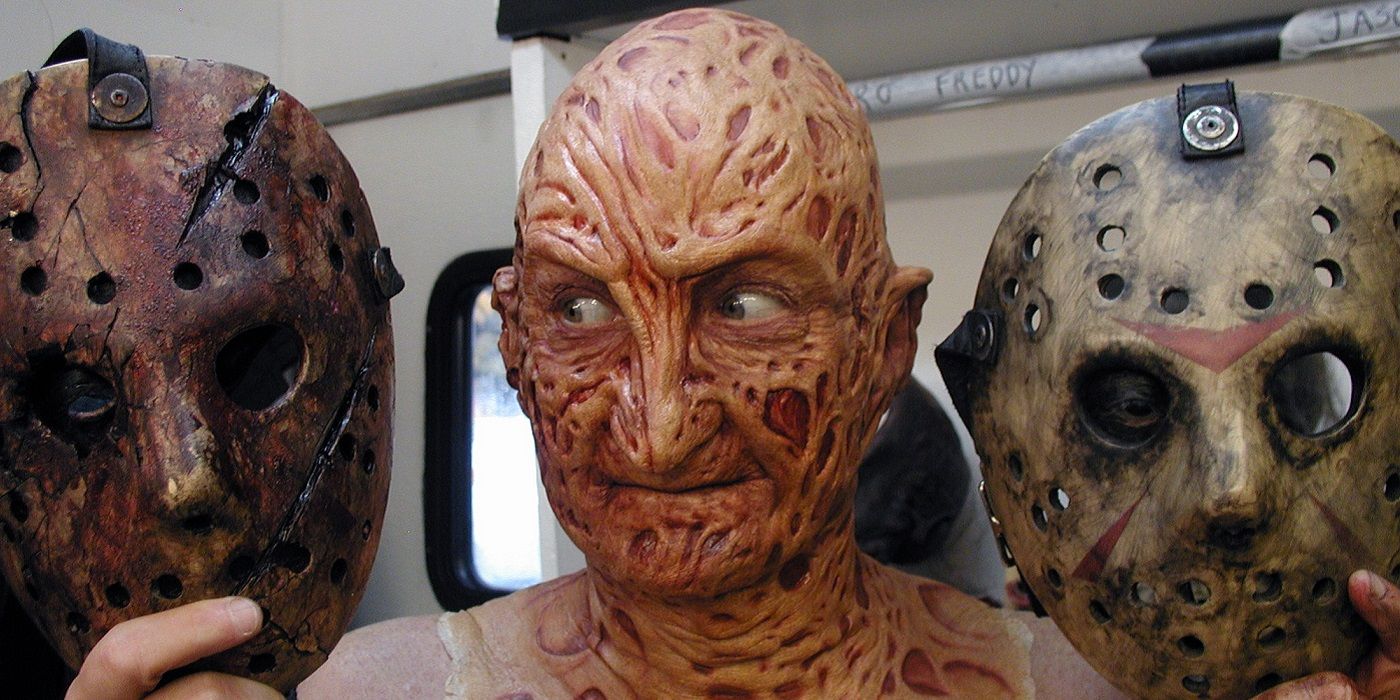 Freddy Krueger holding up Jason Voorhees' mask in Hollywood Dreams & Nightmare The Robert Englund Story