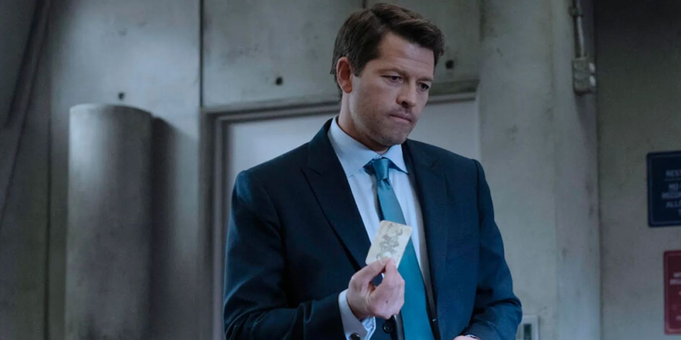 Misha Collins as Harvey Dent holding a piece of paper in The CW's Gotham Knights