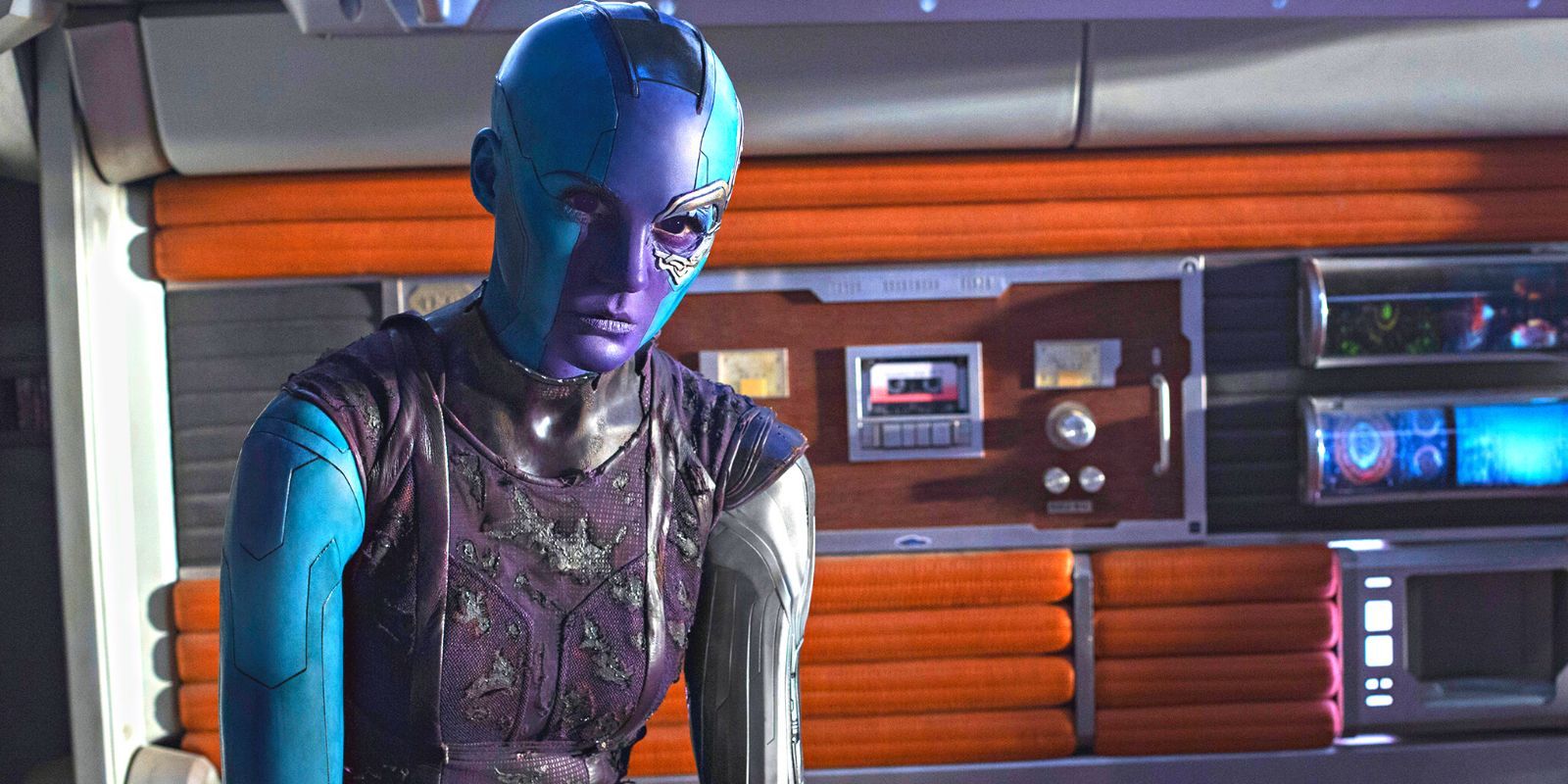 Nebula sitting the Guardian's ship, Star-Lord's tape player visible behind her in GotG 2