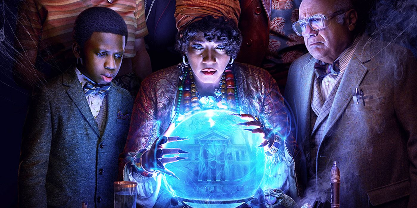 Tiffany Haddish, Danny DeVito and Chase W. Dillon stare into a crystal ball showing the titular haunted mansion.