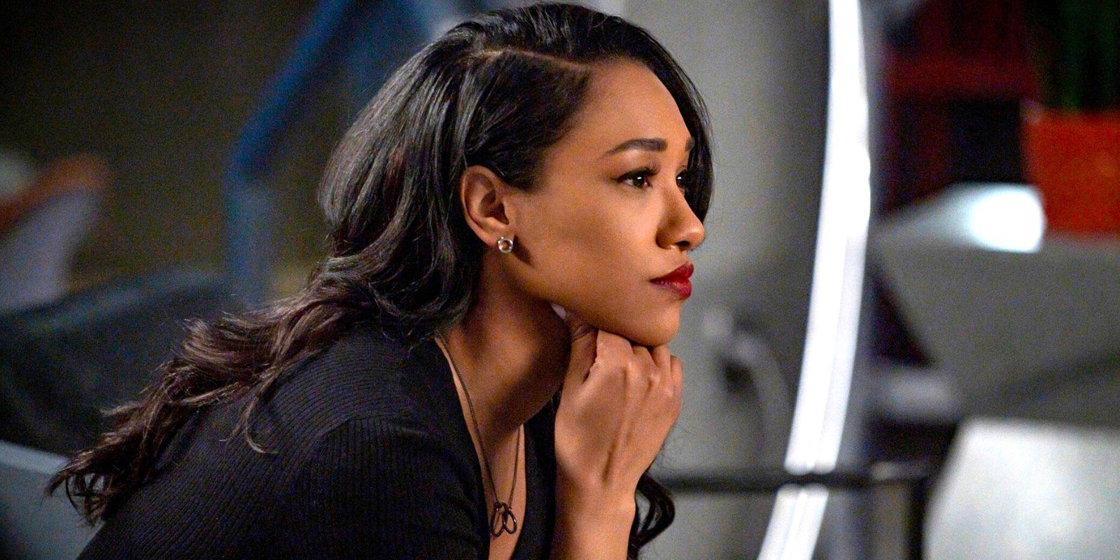 Iris West in The Flash ponders something, leaning her chin on her fist