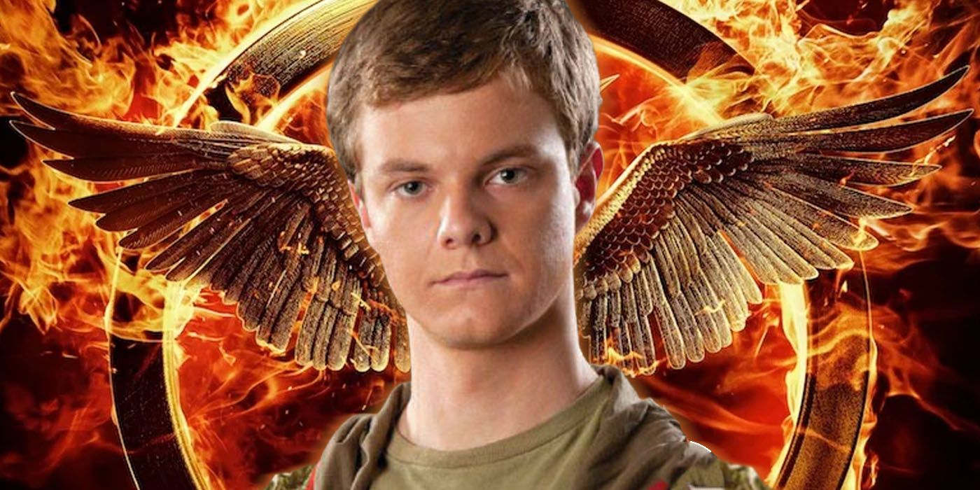 Jack Quaid as Marvel in front of a flaming mockingjay from The Hunger Games