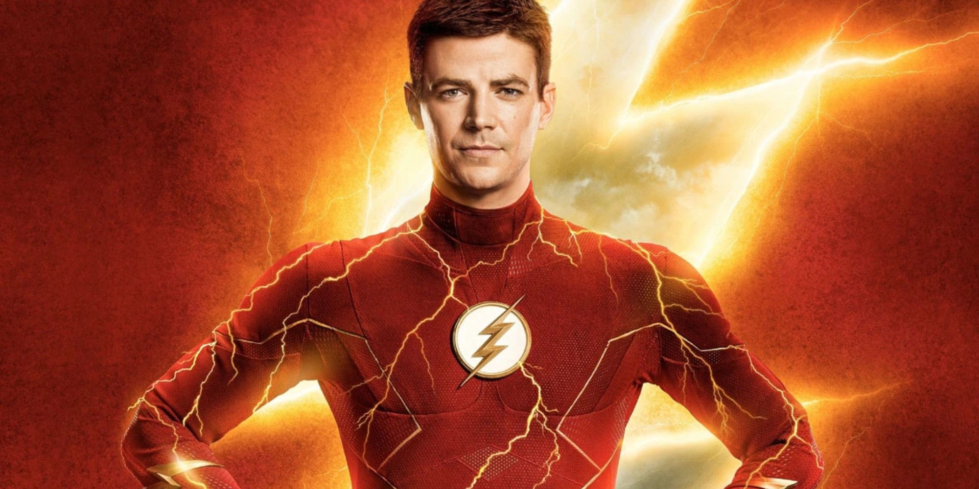 Grant Gustin with arms akimbo in The Flash suit without mask and lightning behind him