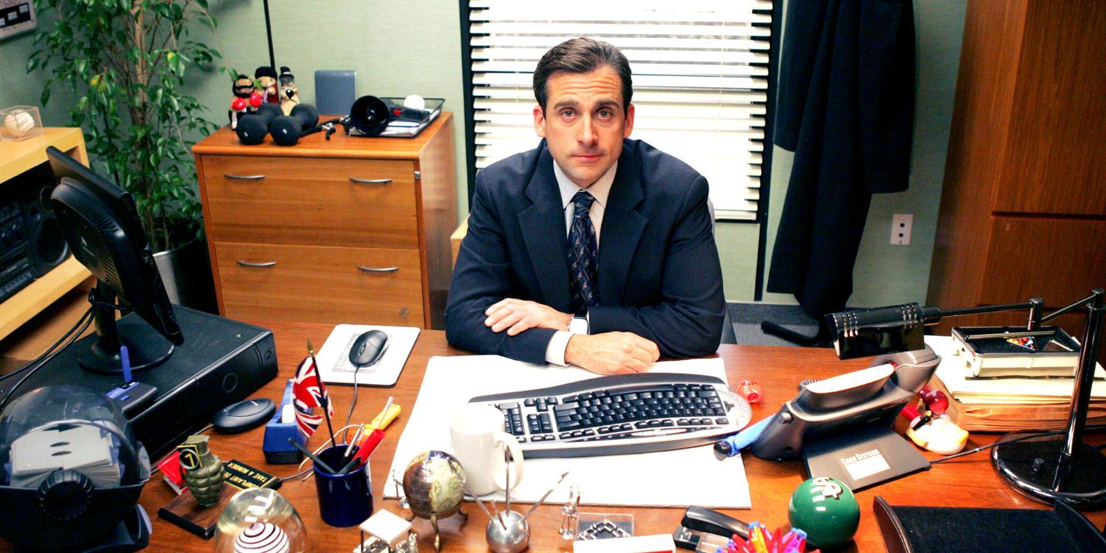 Steve Carrell sitting at a desk in The Office