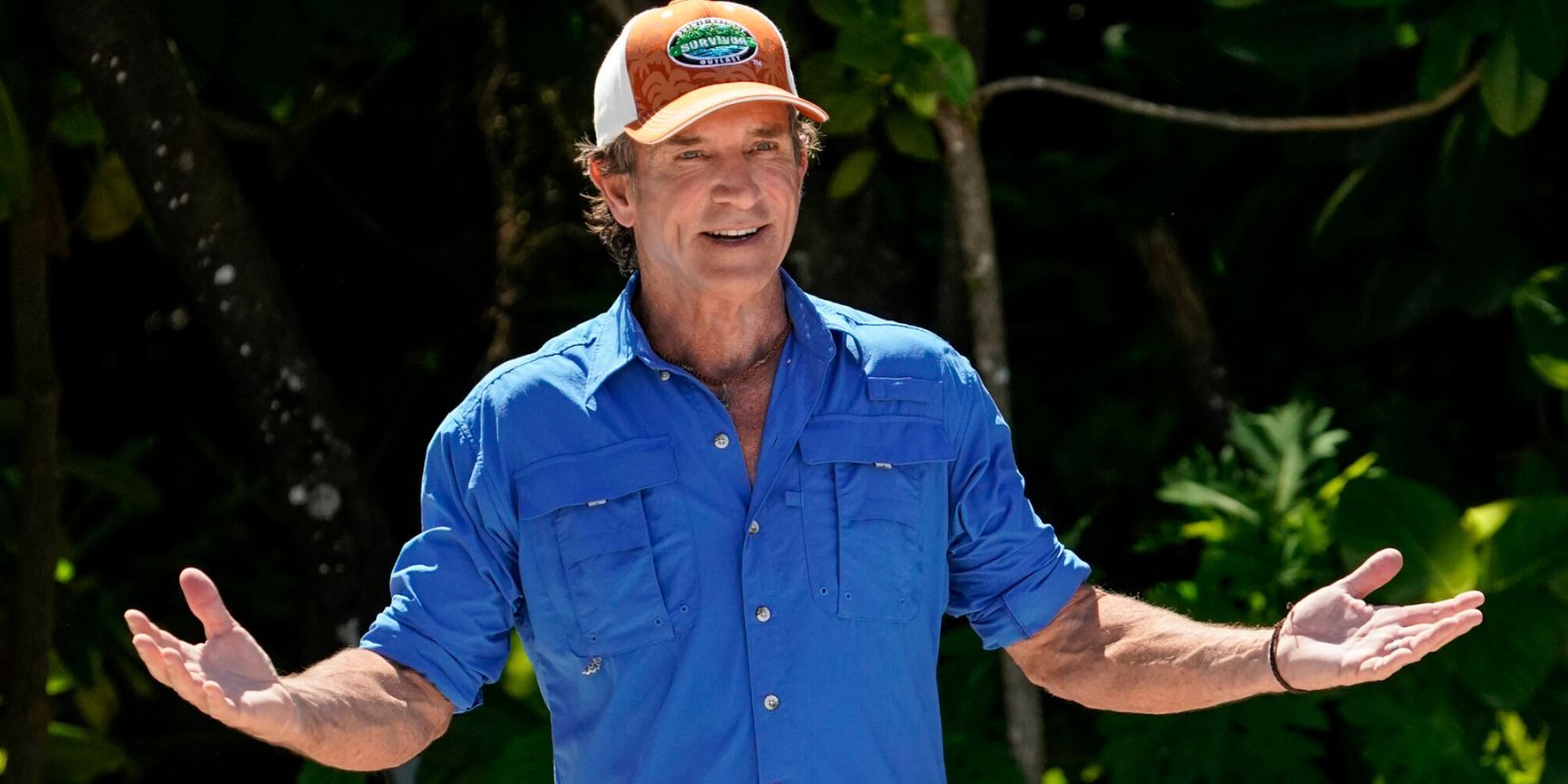 Jeff Probst with his arms wide open on the set of Survivor