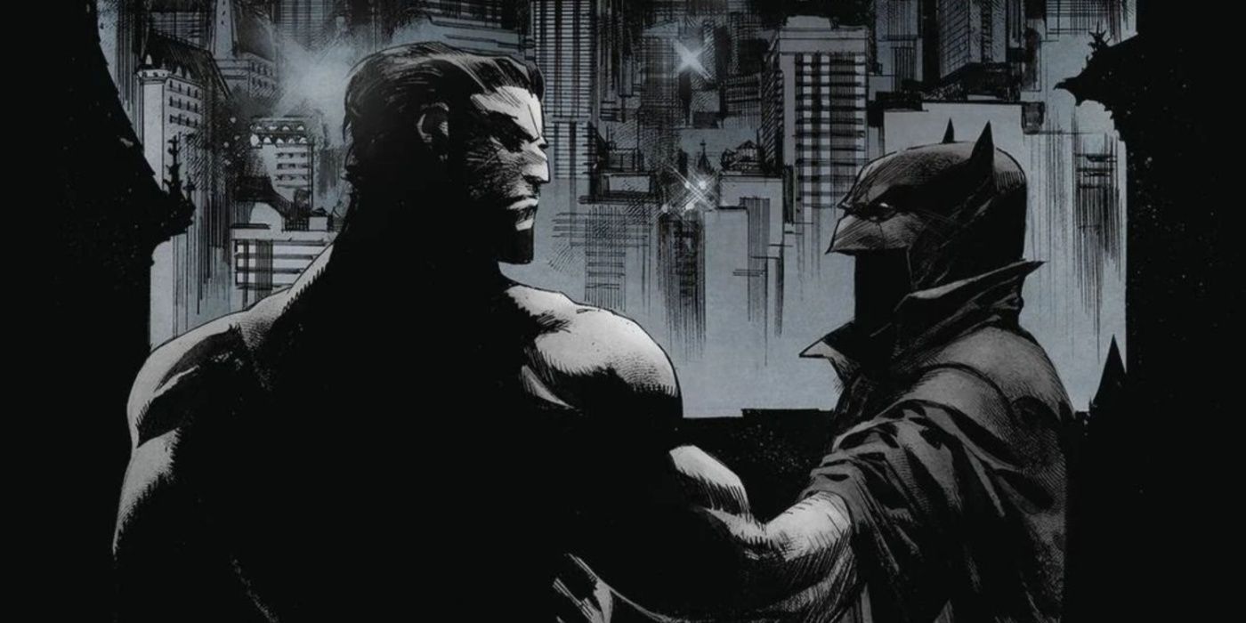 Bruce Wayne holding his cape and cowl in front of him with Gotham's cityscape in the background.