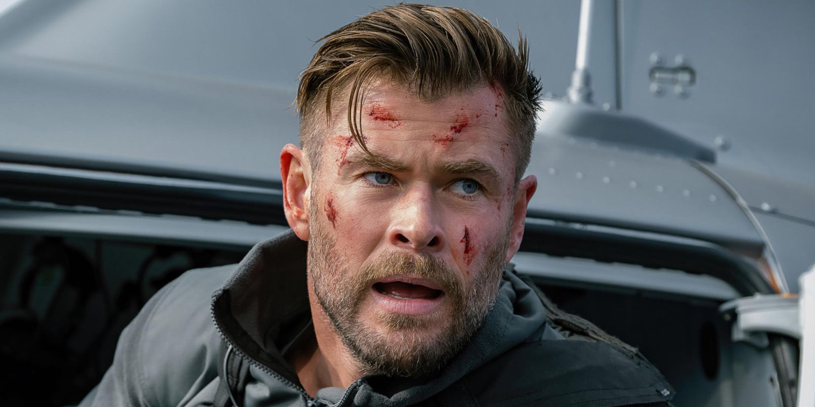 Chris Hemsworth as Tyler Rake in Extraction 2 wih bloody cuts over his face.