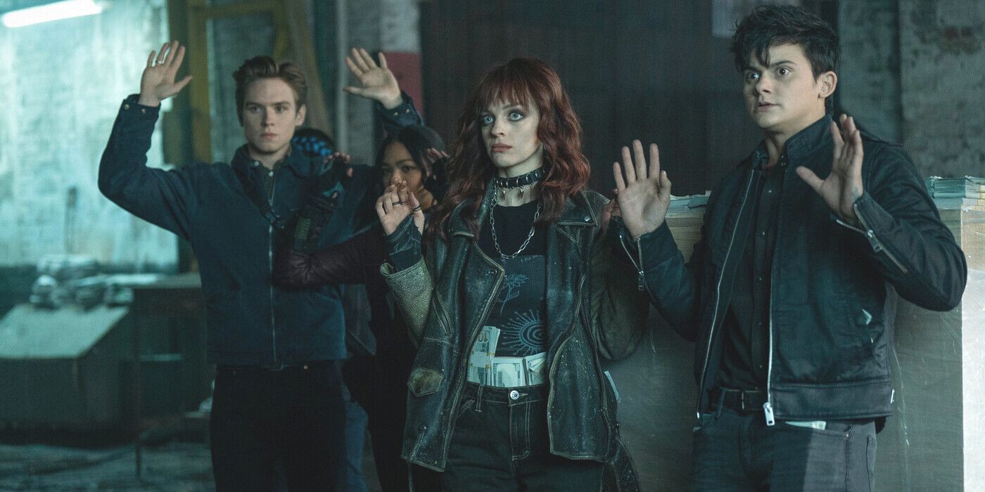 Gotham Knights' Cullen, Duela and Turner raise their hands in surrender after being caught