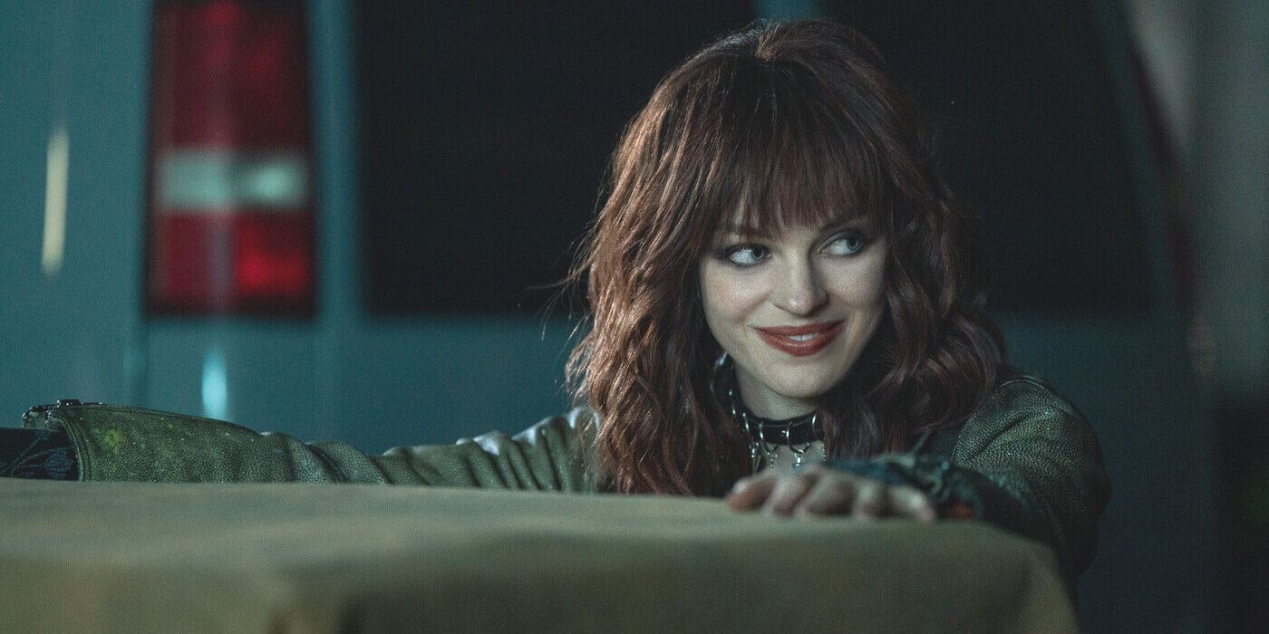 Gotham Knights' Duela (Olivia Rose Keegan) smiles in a warehouse