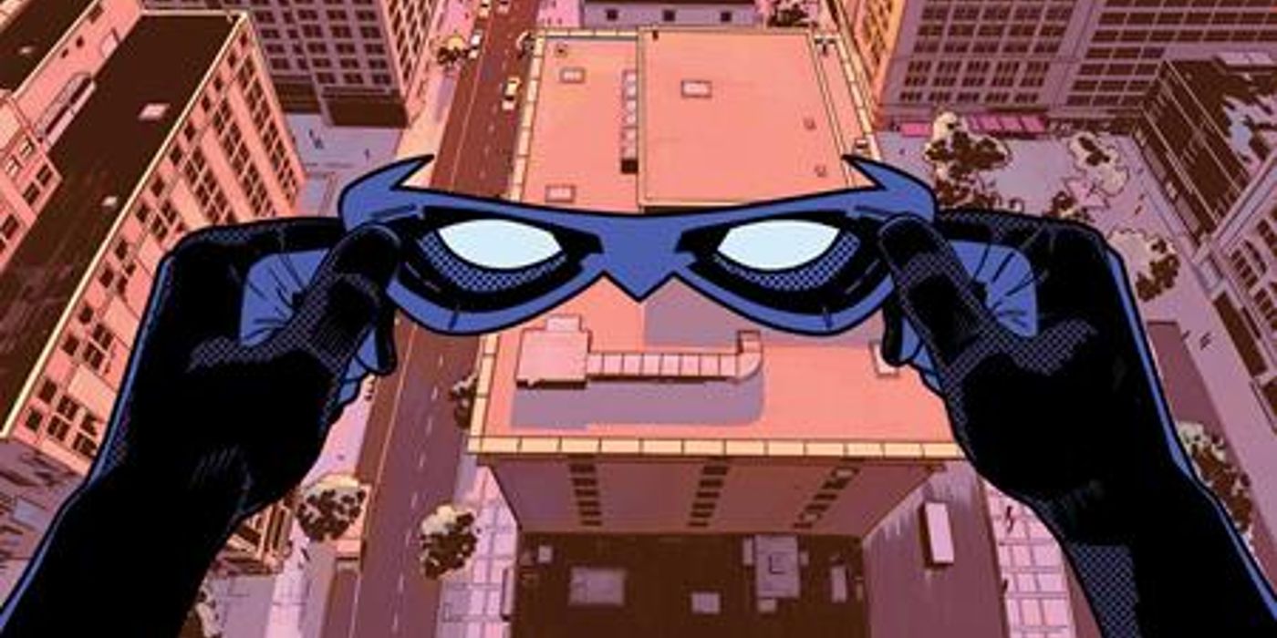 POV shot of Nightwing about to put on his domino mask before leaping into action over Bludhaven