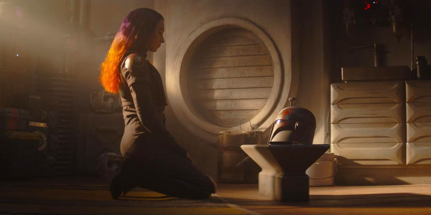 Sabine Wren (Natasha Liu Bordizzo) kneeling and looking at her Mandalorian helmet in Ahsoka.