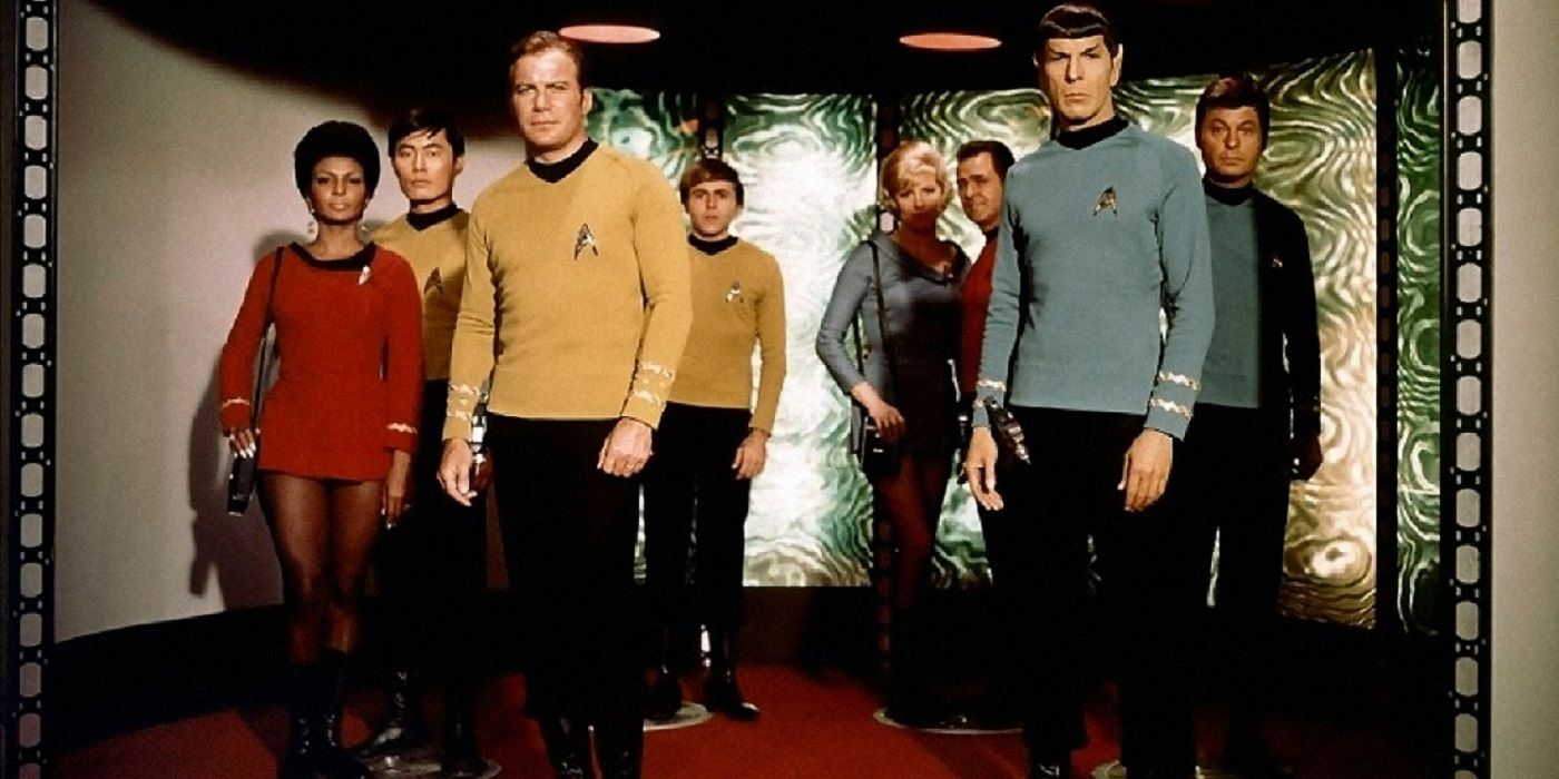 Star Trek the Original series crew standing on the transporter