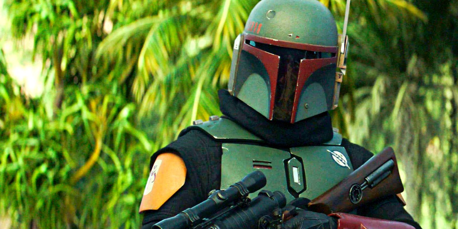 Boba Fett holding a rifle in front of a green forest