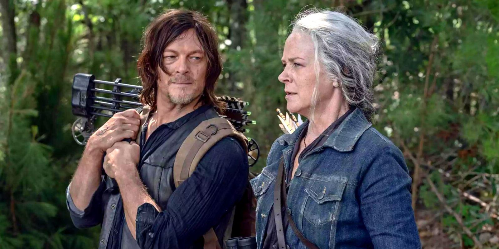 Daryl and Carol standing in a forest in The Walking Dead