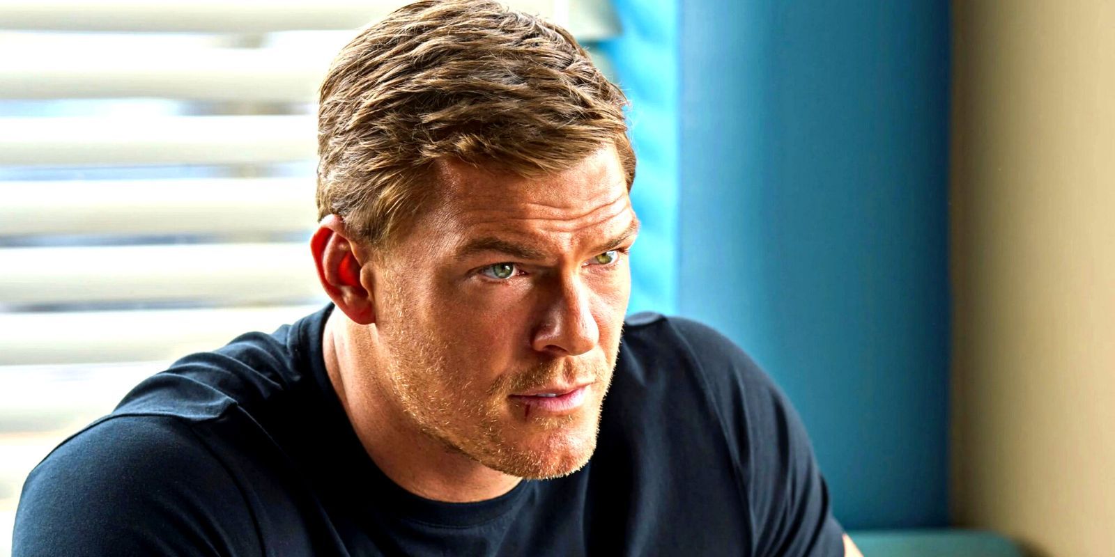 Alan Ritchson looking stoic