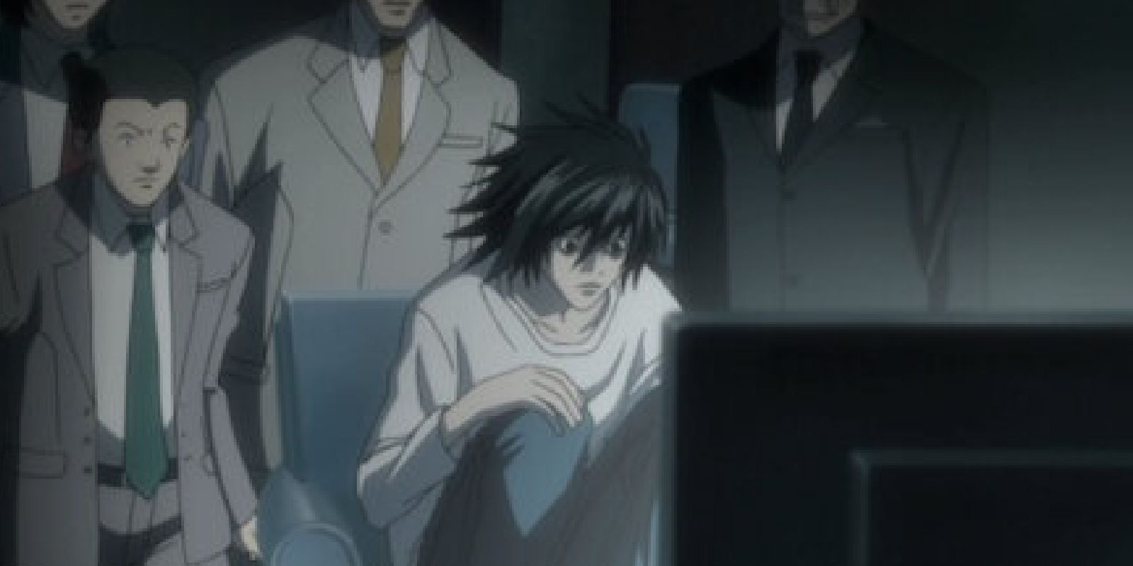 L from the Death Note anime looks at a screen 