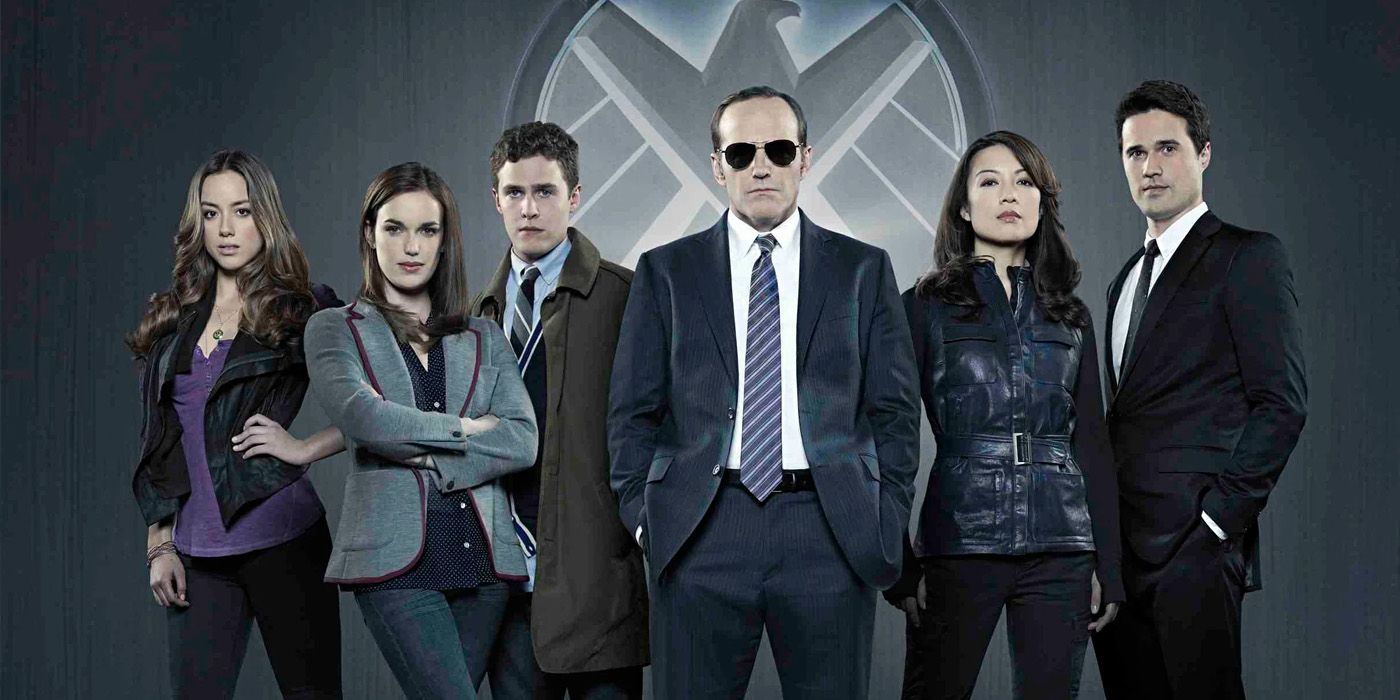 The Season 1 cast poses with the SHIELD logo behind them in Marvel's Agents of SHIELD.