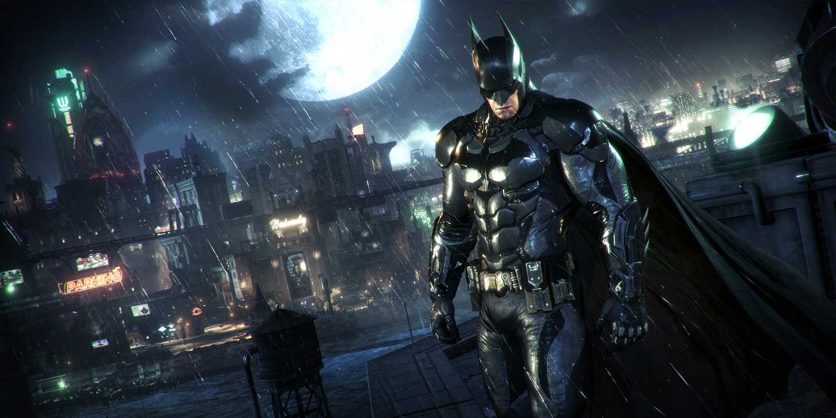 Batman standing on a rooftop with Gotham's cityscape in the background in Arkham Knight.