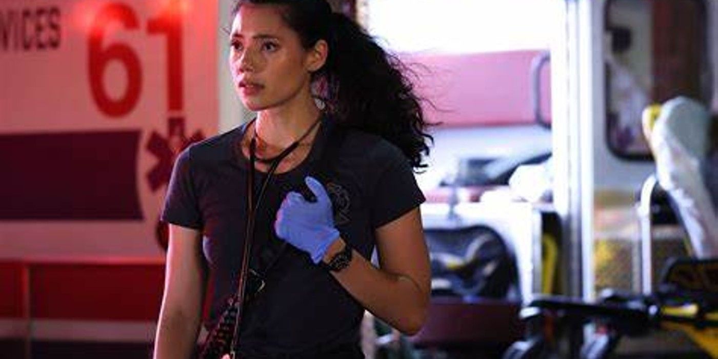 Violet Mikami stands ready at the disaster scene with an ambulance behind her in Chicago Fire