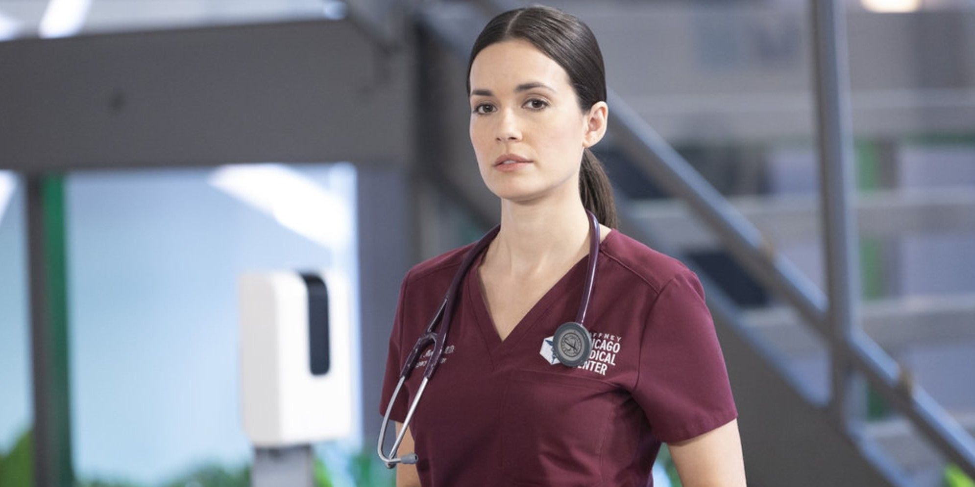 Natalia Manning gazes at the audience in her doctor's uniform with a stethoscope around her neck in Chicago Med 