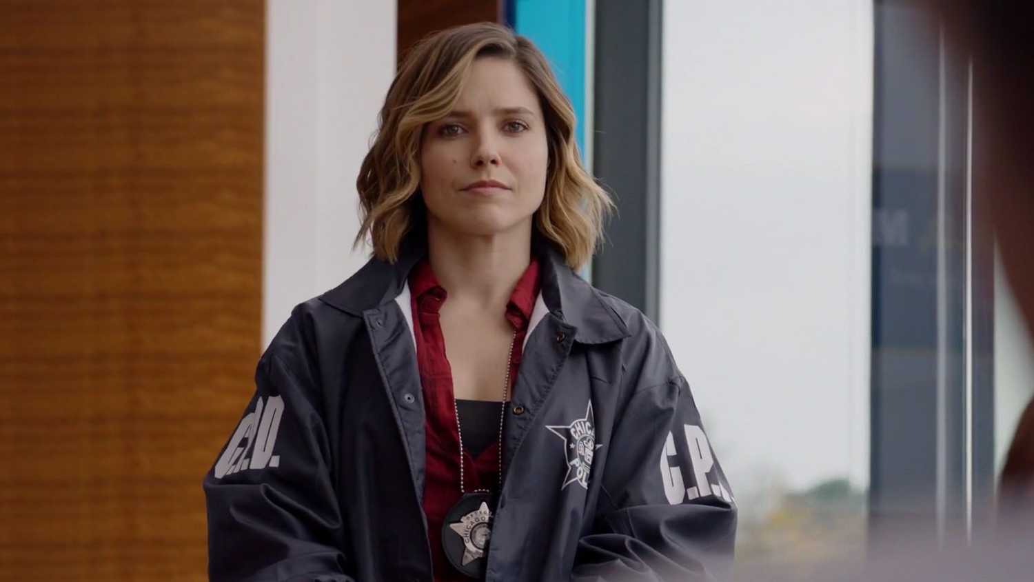 Erin Lindsay (Sophia Bush) looks at the audience in her police jacket in Chicago PD