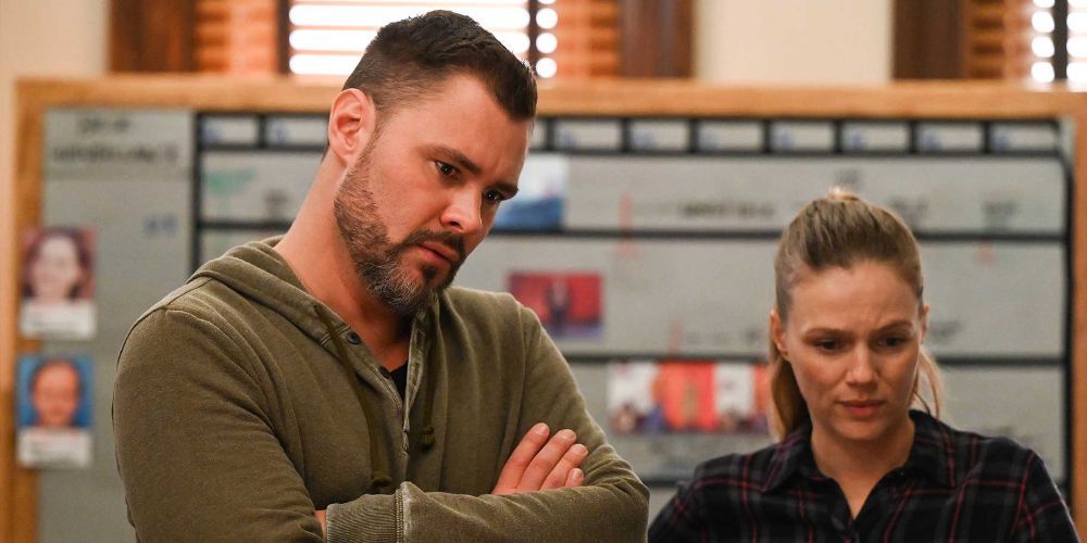 Adam Ruzek, played by Patrick John Flueger, and Hailey Upton, played by Tracy Spiridakos, look at something together on Chicago P.D.