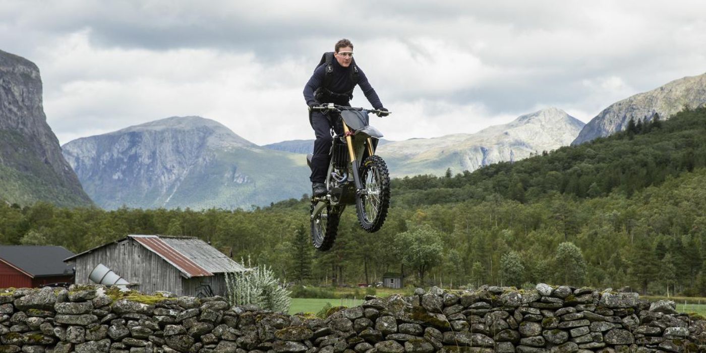 Tom Cruise drives a motorcycle over a stone wall in Mission: Impossible - Dead Reckoning Part One