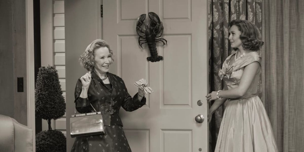 Debra Jo Rupp's Mrs. Hart excitedly greeting and Elizabeth Olsen's Wanda in WandaVision.