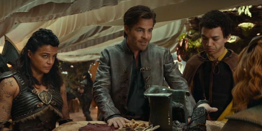 Holga, Edgin y Simon se encuentran con Doric en una mesa en Dragones y Mazmorras: Honor entre ladrones.