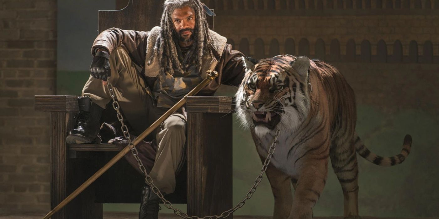 Ezekiel on his thrown with Shiva beside him in The Walking Dead.