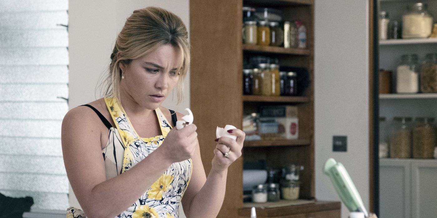 Florence Pugh as Alice Chambers holding an egg in Don't Worry Darling