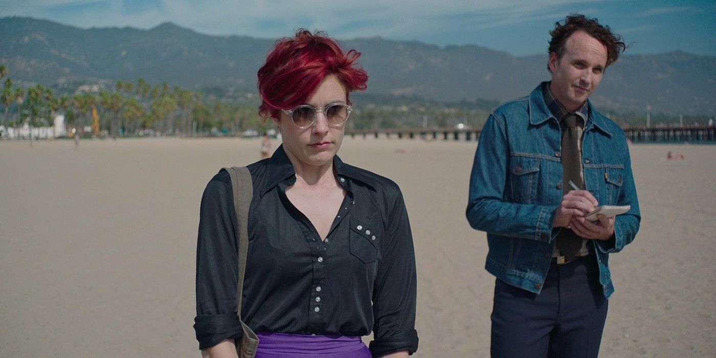 Abbie Porter and her assistant observe their latest project on the beach in 20th Century Women