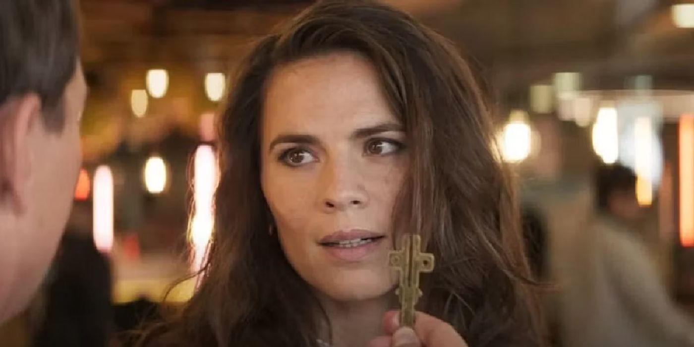 Hayley Atwell as Grace looks at Ethan holding a key in Mission Impossible