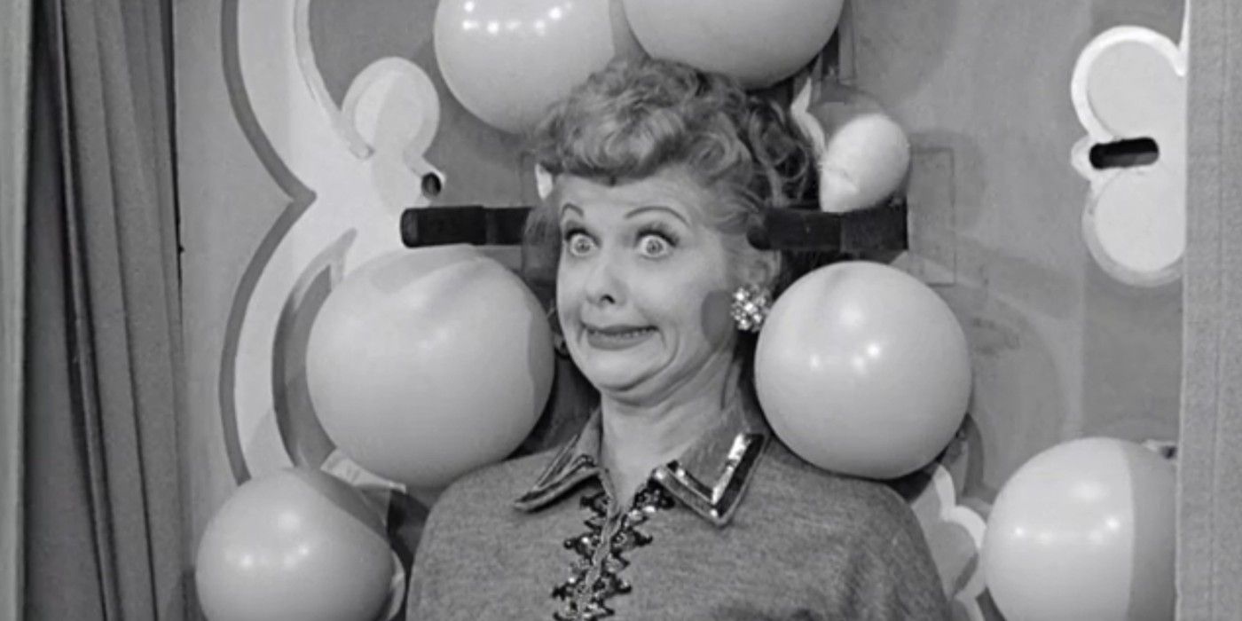 Lucy gives a terrified, wide-eyed smile while participating in a knife-throwing act in I Love Lucy, Lucy Tells The Truth